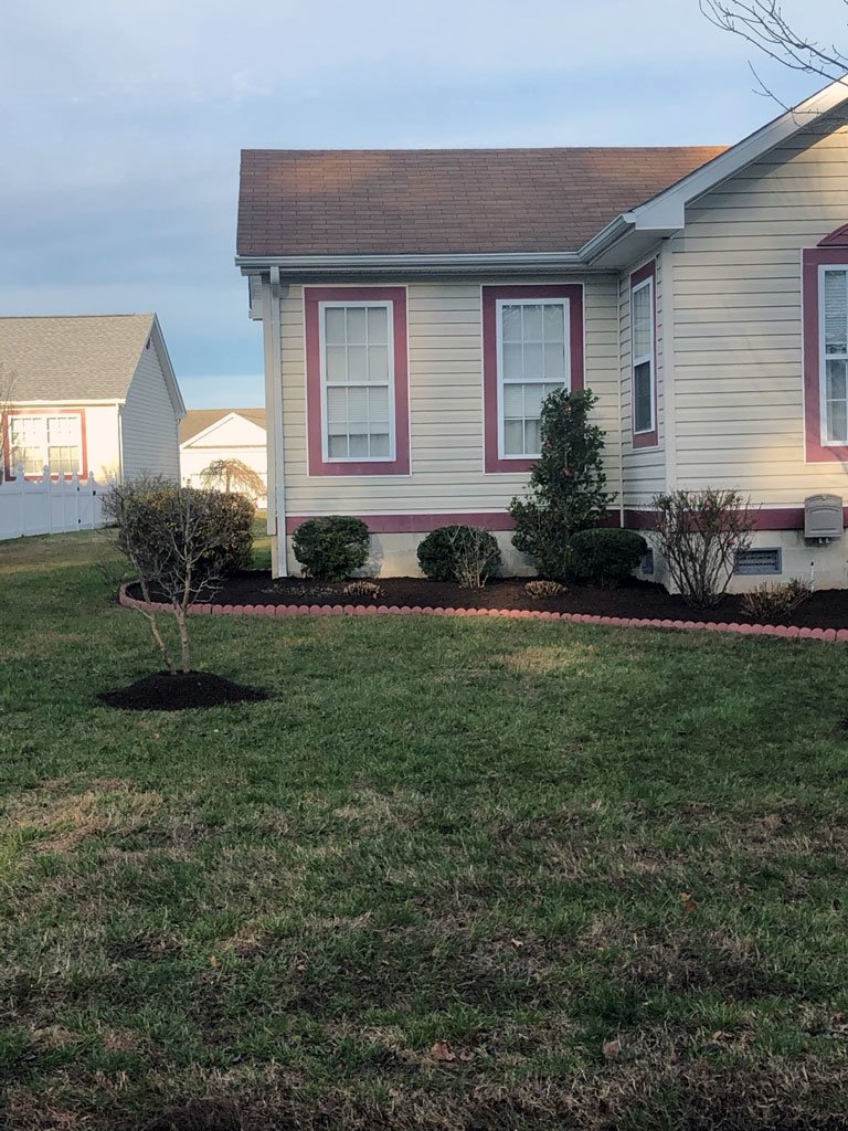 nicely trimmed lawn and mulchbeds around home