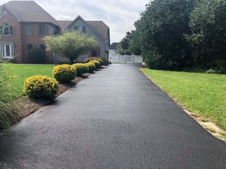 sealcoated asphalt driveway leading to home